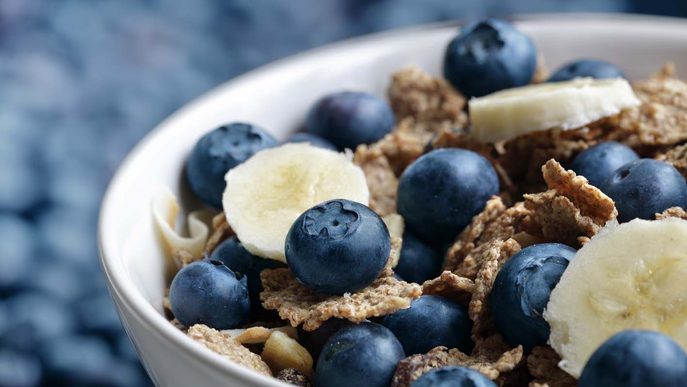 Healthy breakfast with high fibre bran flakes, blueberries and banana