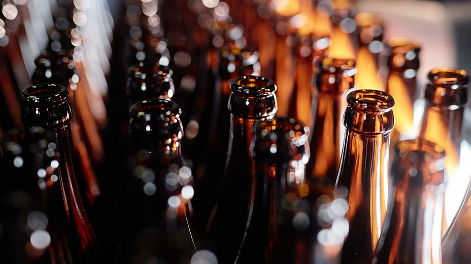 open glass bottles at craft beer factory