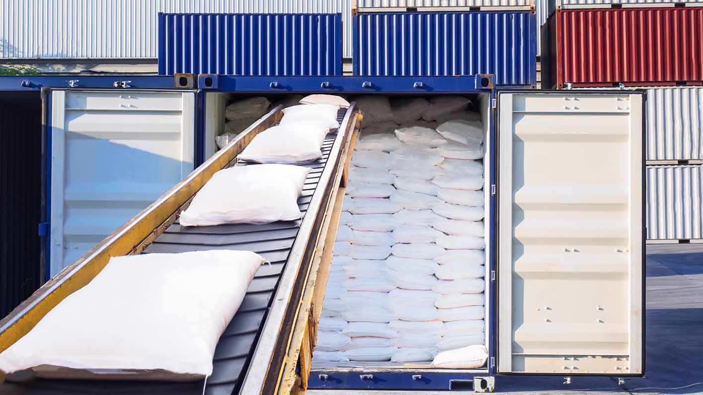 Bags of sugar on a conveyor belt ready for export