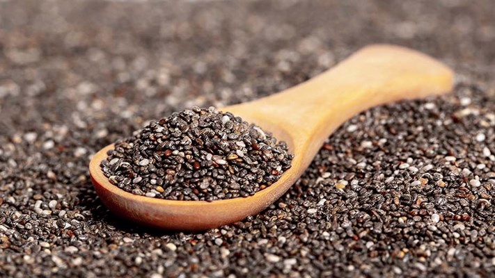 Chia seeds close up, with a wooden spoon