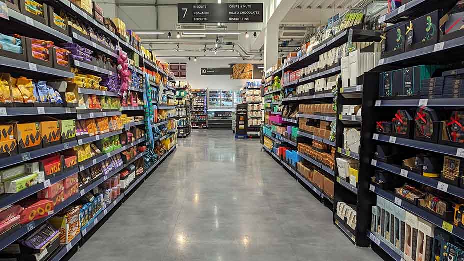 Supermarket aisle with shelves full of food products