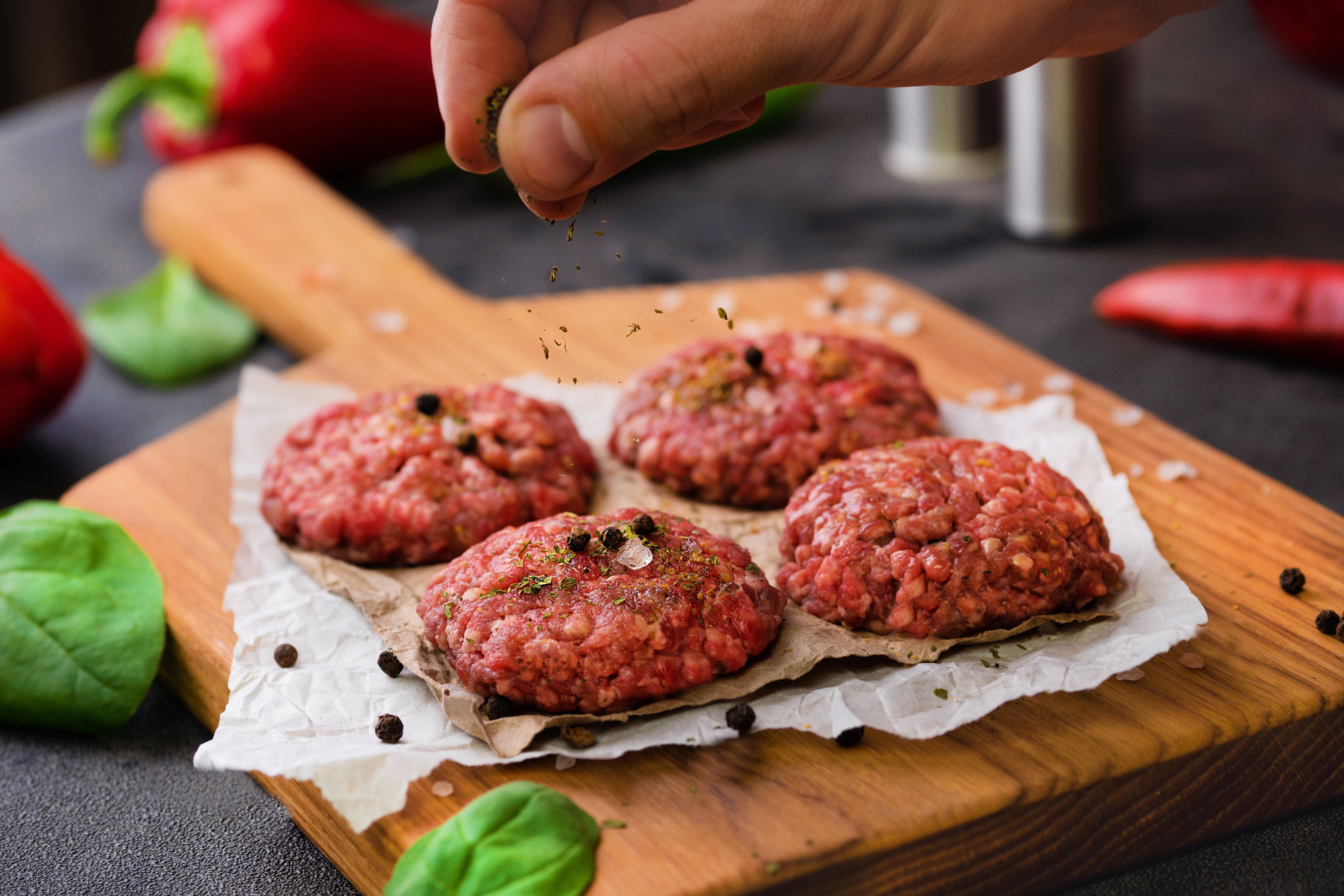 uncooked meat balls on cutting board