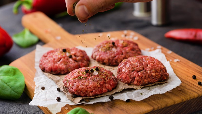 uncooked meat balls on cutting board