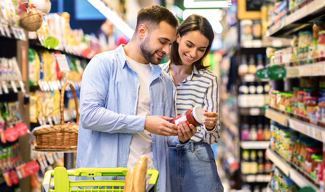 Happy Couple Buying Food In Supermarket