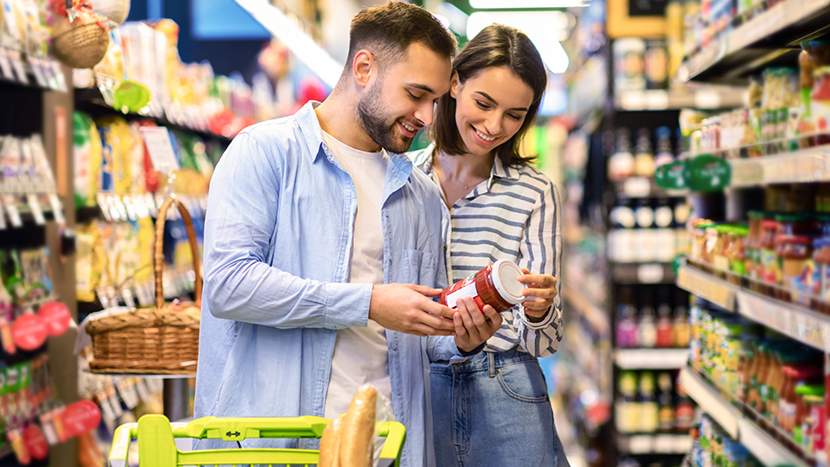 Happy Couple Buying Food In Supermarket