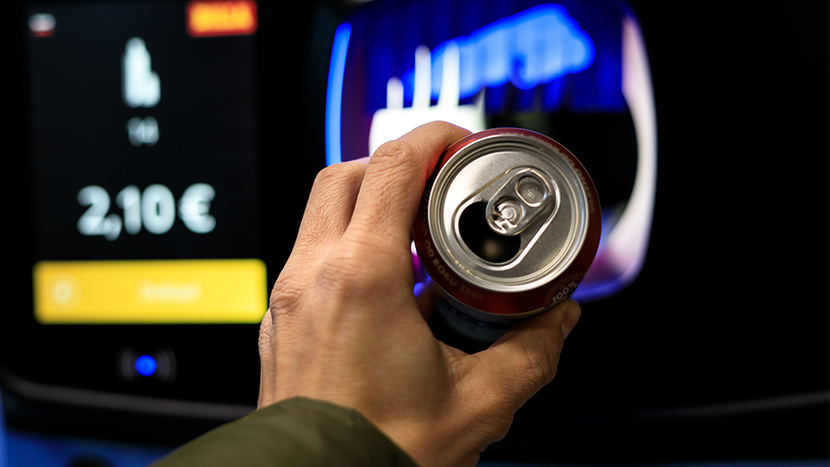 recycling a can for cash in a supermarket