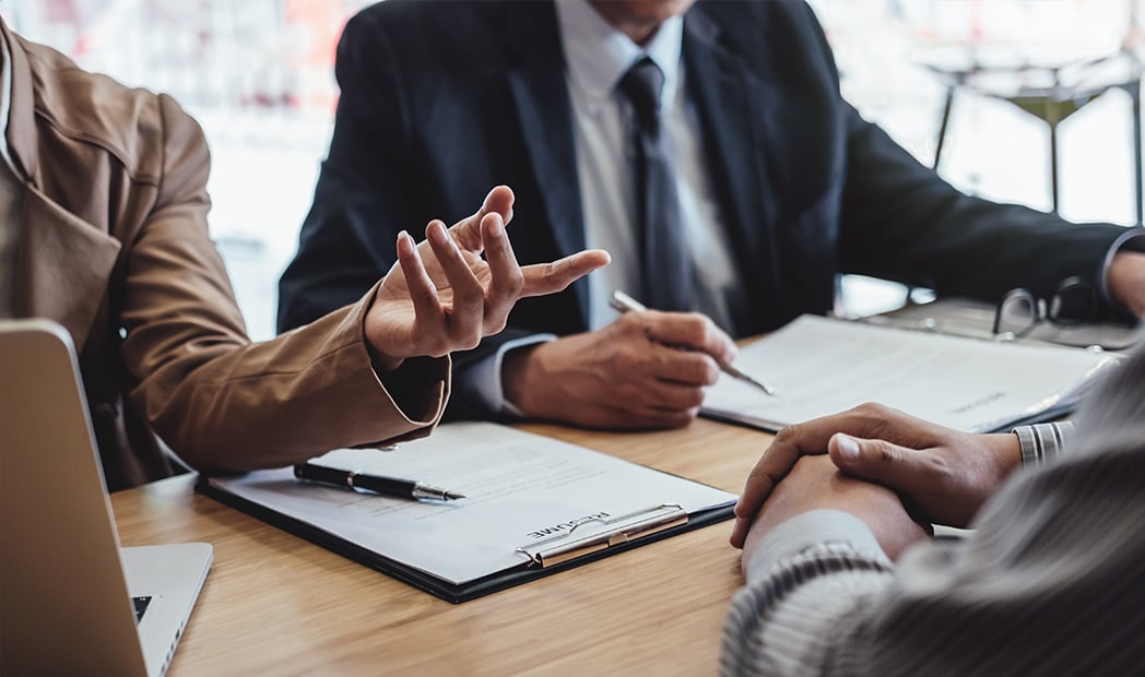  senior managesr reading a resume during a job interview