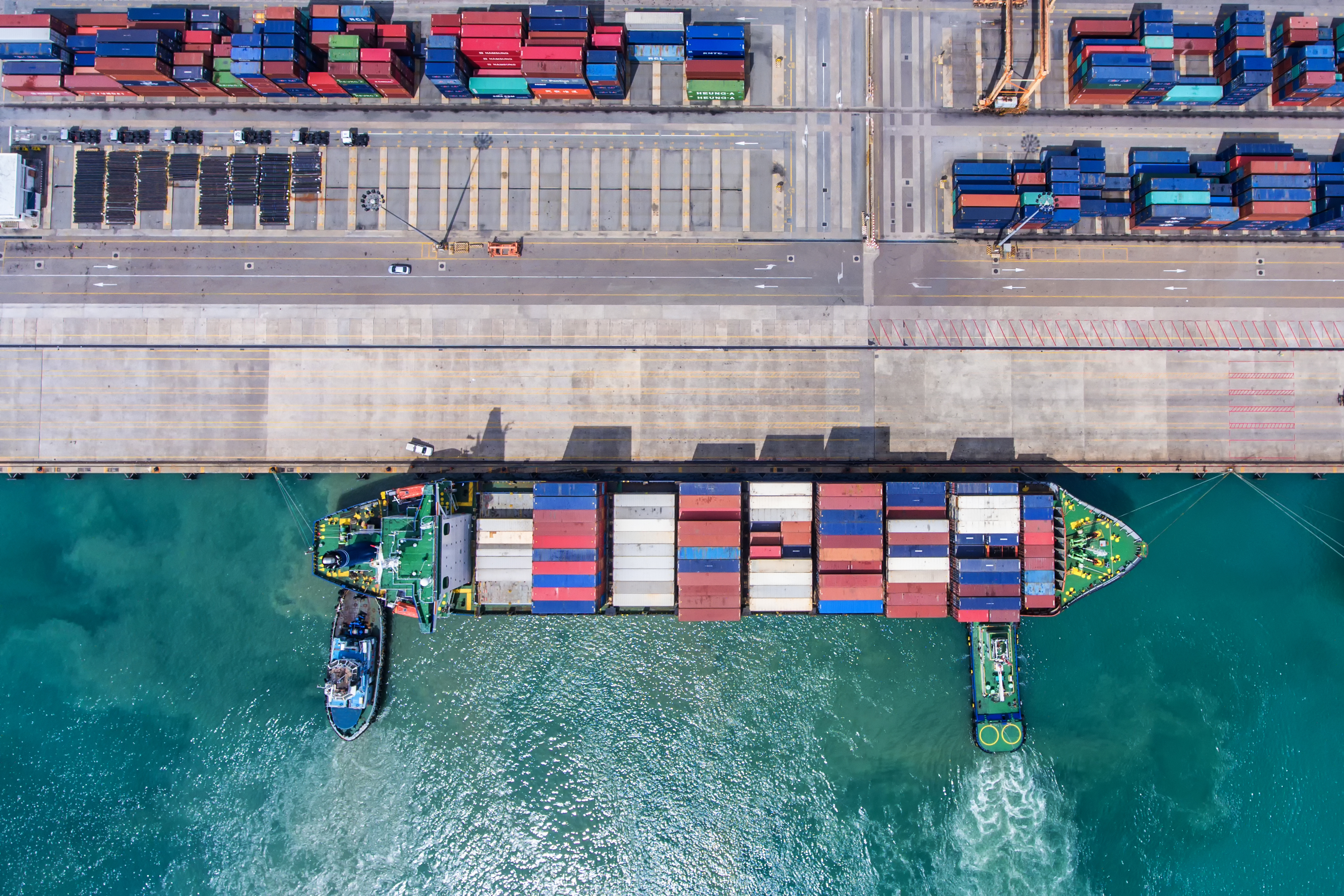 Container ship in port fully loaded with containers. Aerial view