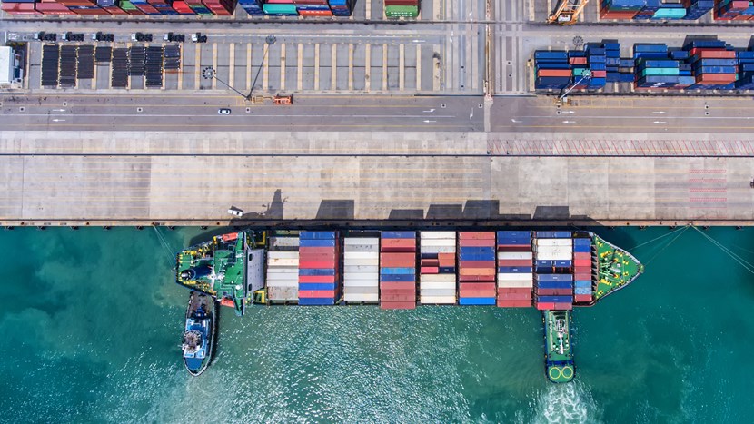 Container ship in port fully loaded with containers. Aerial view