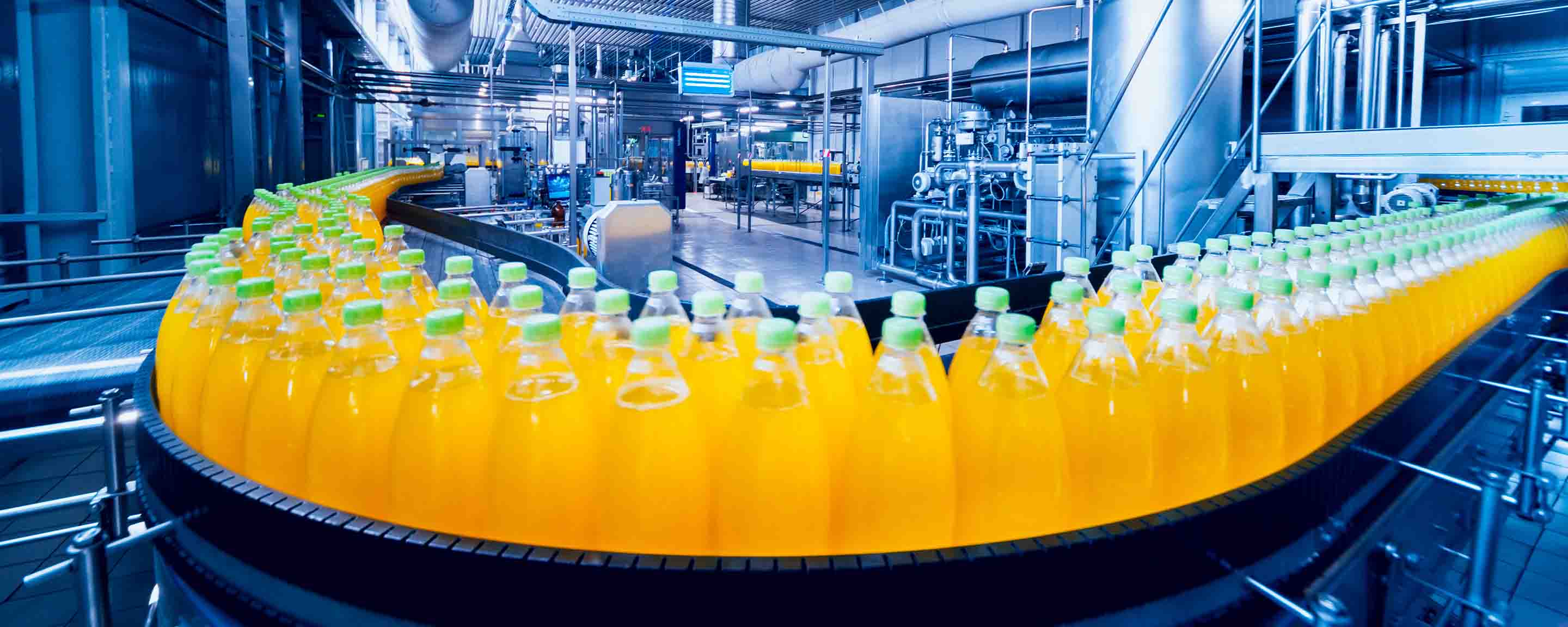Conveyor with bottles of orange juice