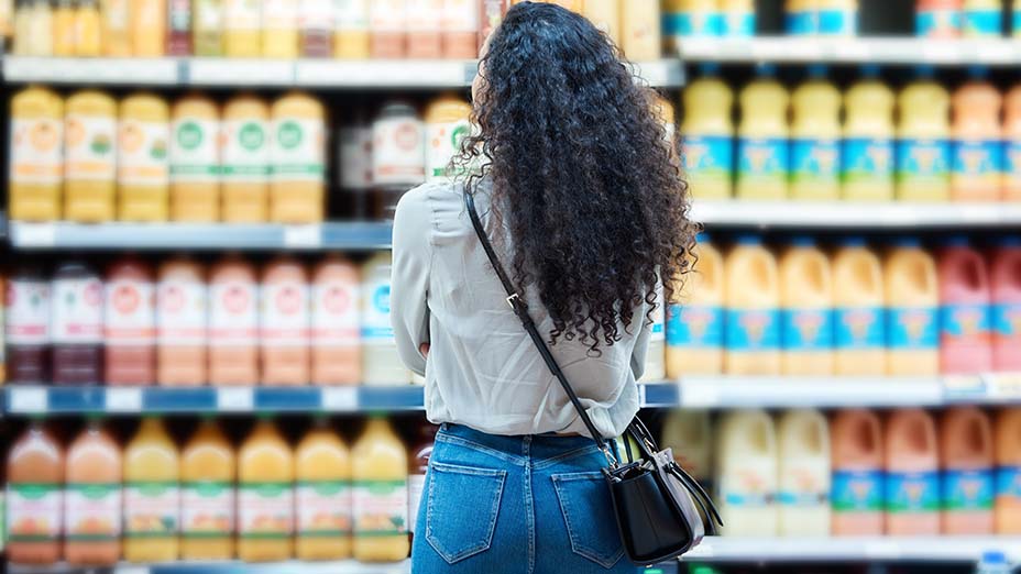 customer shopping for juice at supermarket